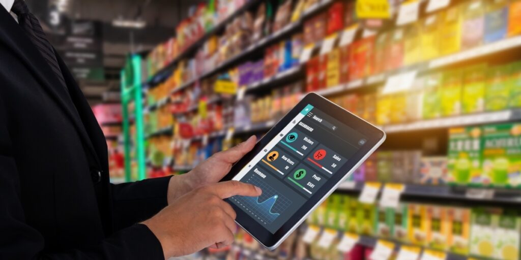 Person holding a tablet in a grocery store