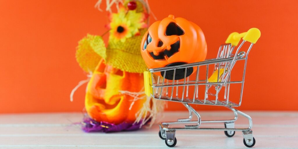 A small shopping cart with a pumpkin inside