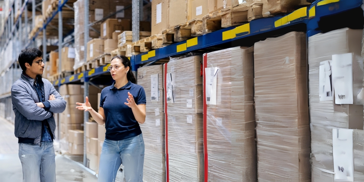 A room full of inventory with two people having a discussion