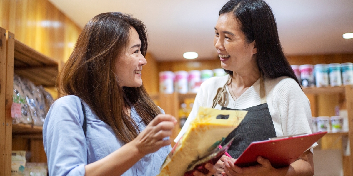 Employee speaking to a customer about her experience