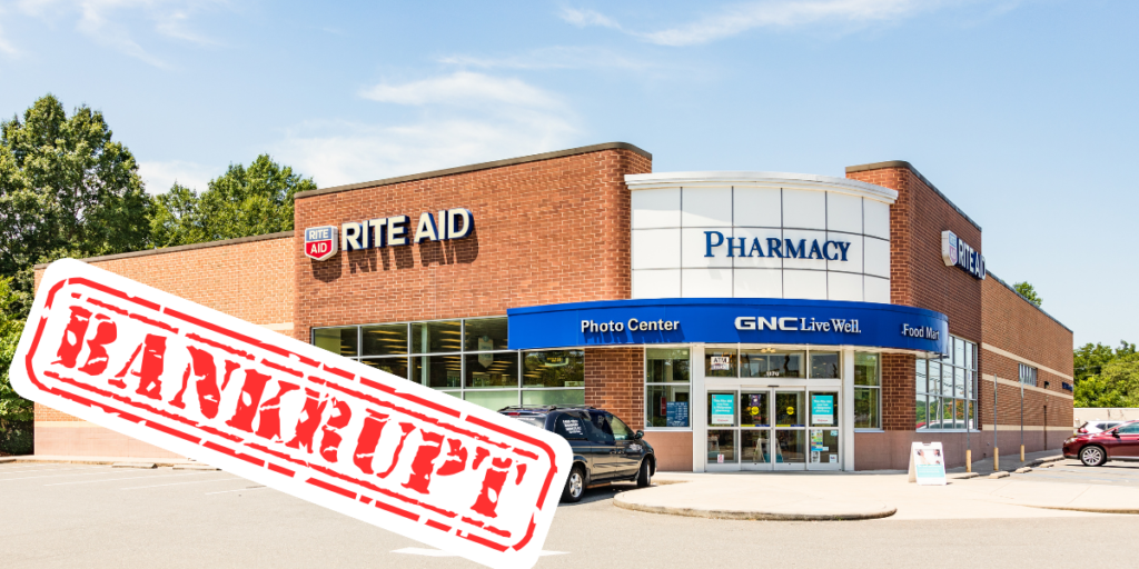 Image of the front of a Rite Aid with a "Bankrupt" sticker on top
