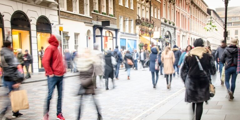 A crowd of people walking on a street