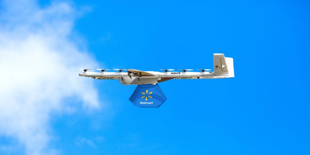 Drone holding a Walmart delivery in the sky